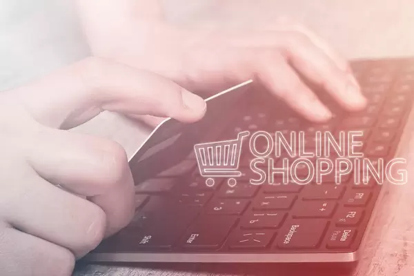 Online shopping - Hands holding credit card and using laptop