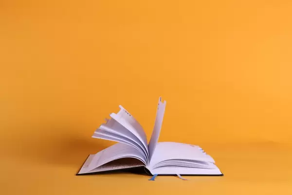 Open book on orange background