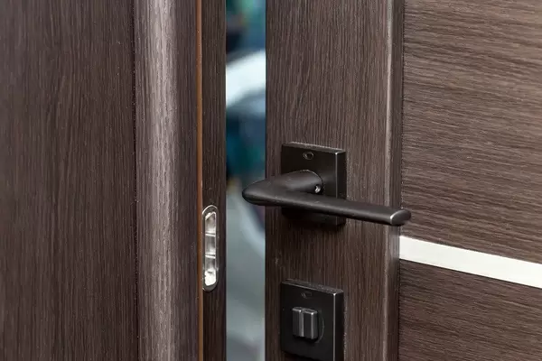 Open brown interior door with handle