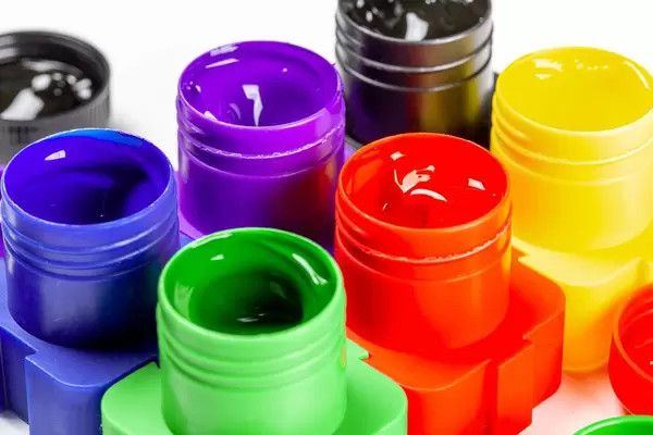 Open jars of paint for drawing, close-up