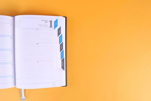 Open notebook on orange background