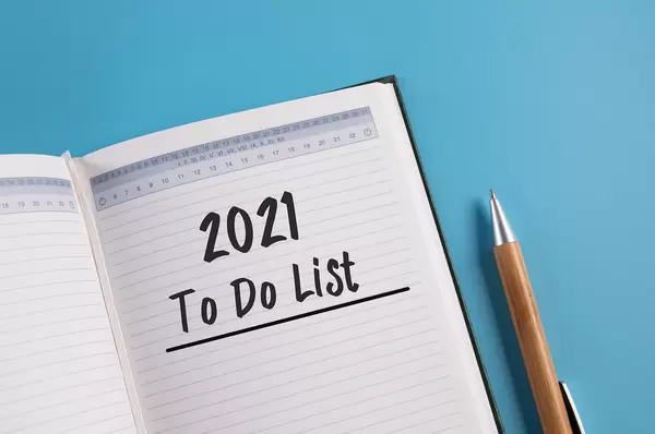 Open notebook with 2021 To do list on blue background