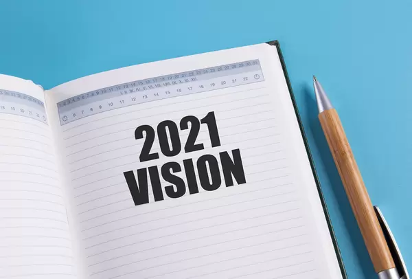 Open notebook with 2021 Vision text on blue background