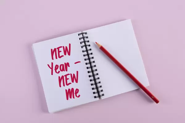 Open notebook with New Year New Me text