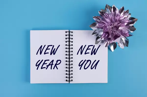 Open notebook with New Year New You text on blue background