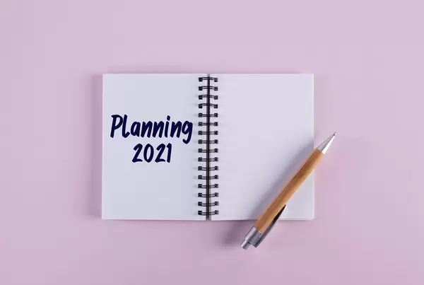 Open notebook with pen and Planning 2021 text