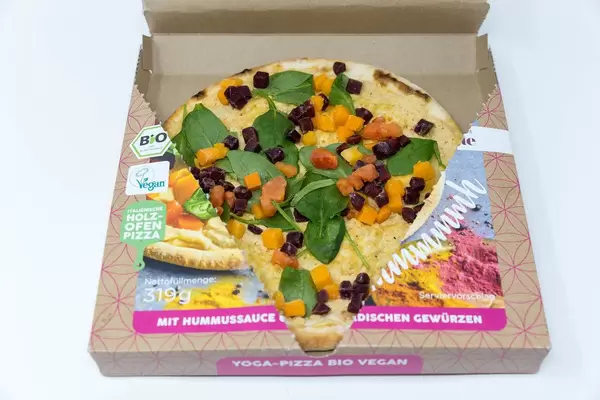 Open package of Followfood Yoga Pizza Vegan. With organic spelt dough and selected organic vegetables. Cooked in wood fired oven in Italy