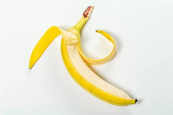 Open ripe banana on white background (Flip 2019)