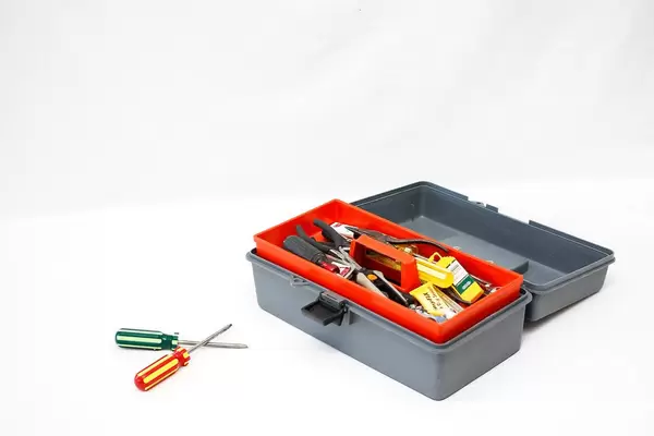 Open Toolbox with Screwdrivers in front of it on white Background