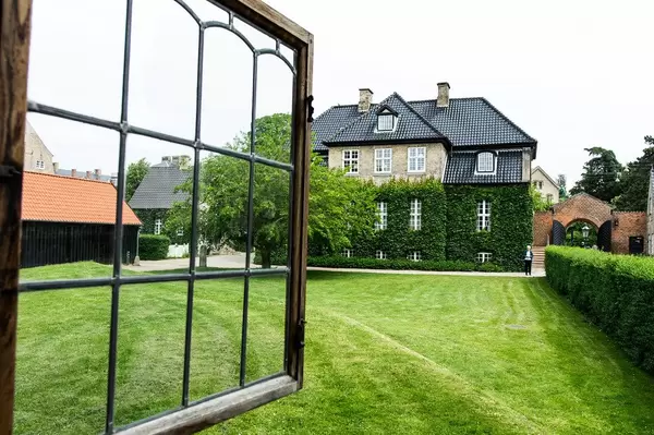 Open window looking out to a green grass field and elegant Danish house (Flip 2019)