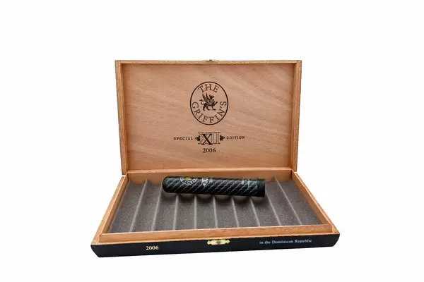 Open wooden box of cigars on white background