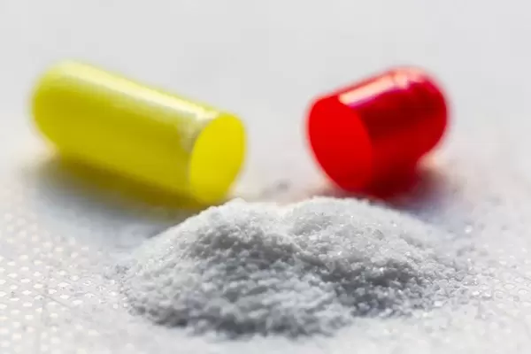 Open yellow-red medical capsule close-up