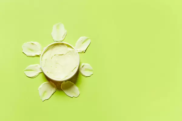 Opened container of sun cream