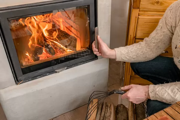 Opening Fireplace To Set More Fire With Wood