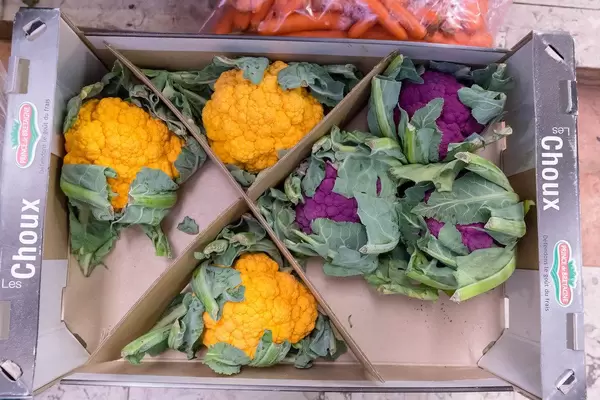 Orange and violet cauliflower in a vegetable crate at Timeout Market Lisbon