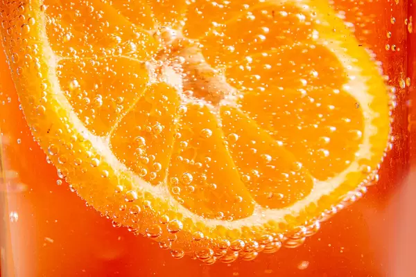 Orange background with fresh tangerine and soda bubbles