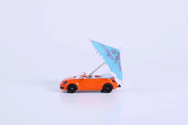 Orange car with blue umbrella
