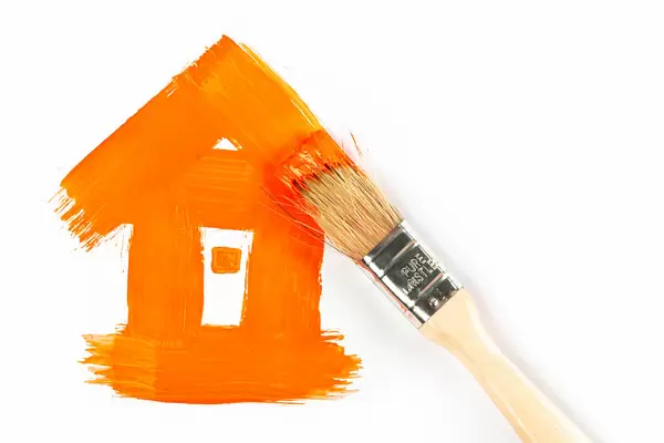 Orange painted house with brush, renovation concept