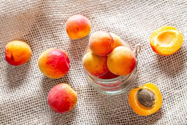 Orange ripe apricots on burlap background (Flip 2019)