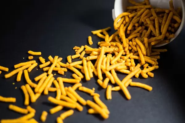 Orange stick chips coming out of a bowl