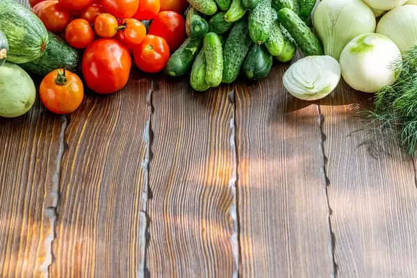 Organic raw vegetables on wooden background