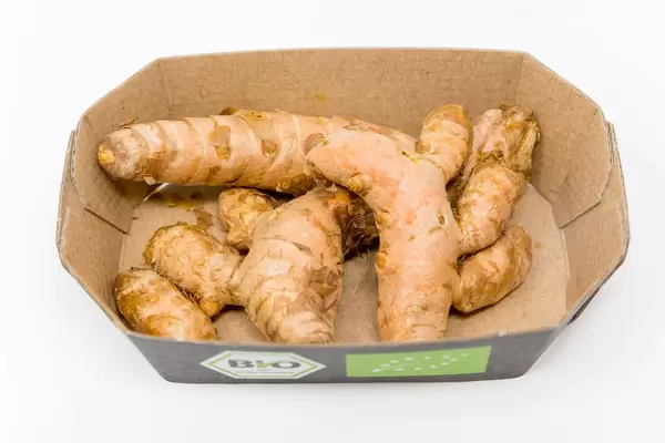 Organic turmeric rhizomes in a cardboard box