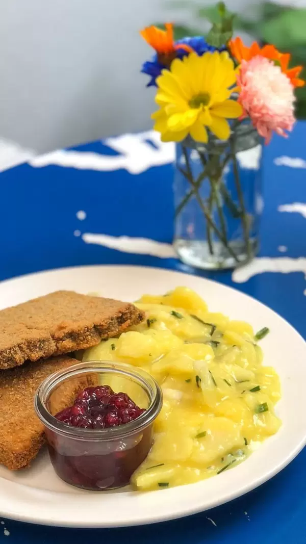 Organic Viennese Schnitzel at Augustin with cranberry sauce and potato salad