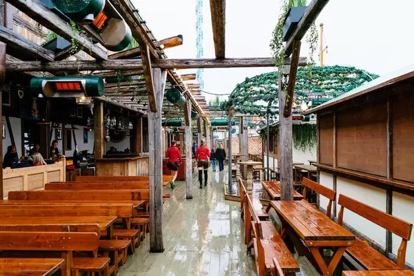 Outside seating at Oktoberfest with waitresses in national clothes serving beer