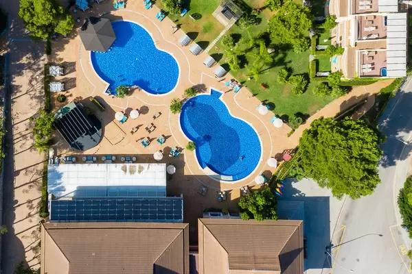 Overhead Drohnenaufnahme von zwei Pools in Achtform bei Cala Mesquida, Mallorca