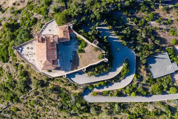 Overhead drone shot of the medieval fortress in Artà, Mallorca. Santuari de Sant Salvador with snake road