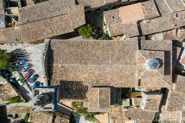 Overhead drone shot: the roof and bell tower of the parròquia de Sant Bartomeu church, Valldemossa