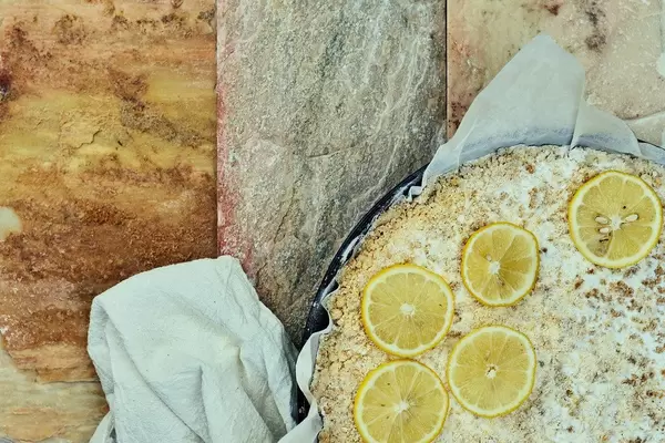 Overhead view of delicious homemade lemon cheesecake on marble background