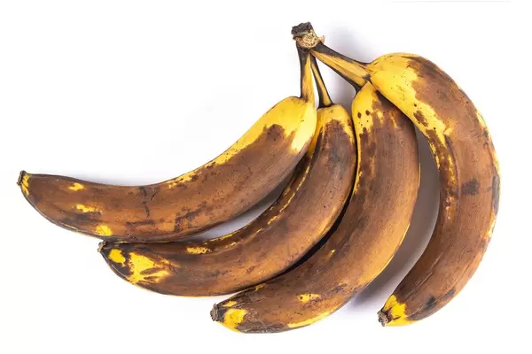 Overripe bananas on a white background, top view