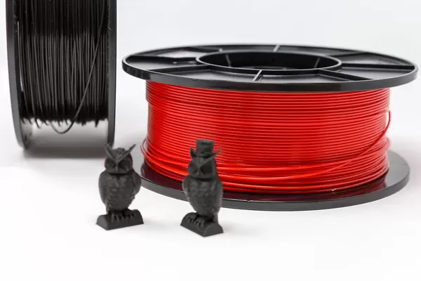 Owls made from black plastic in front of PLA filament