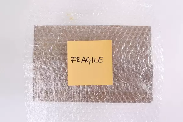 Package in bubble wrap with Fragile text