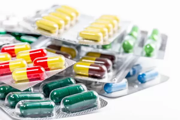 Packages of different tablets and capsules on a white background (Flip 2019)