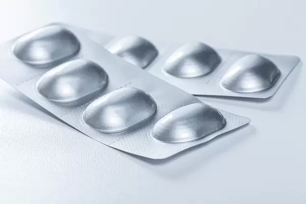 Packed antibiotics in blisters on a white background