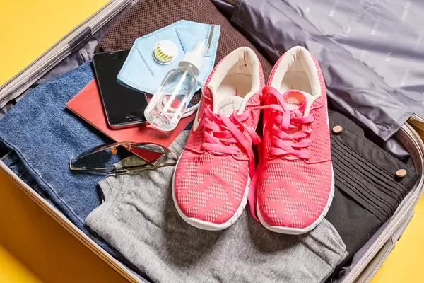 Packed suitcase with travel accessories. Vacation concept