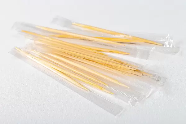 Packed wooden toothpicks on white background (Flip 2019)