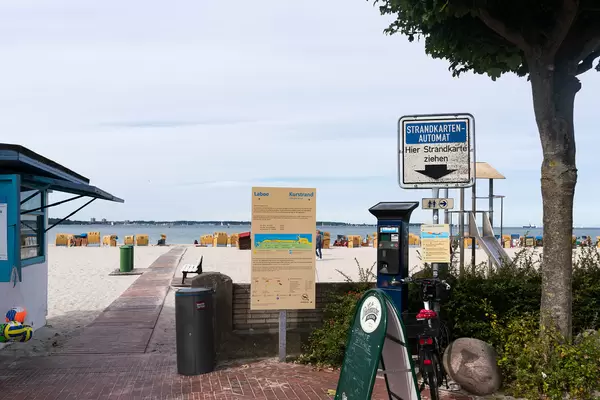 Paid beach entrance with a parking meter style ticket machine at the entrance