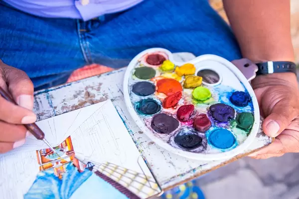 Painter on the street painting a street in Antigua, Guatemala