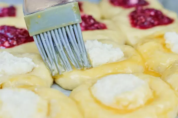 Painting with egg yolks raw sourdough buns