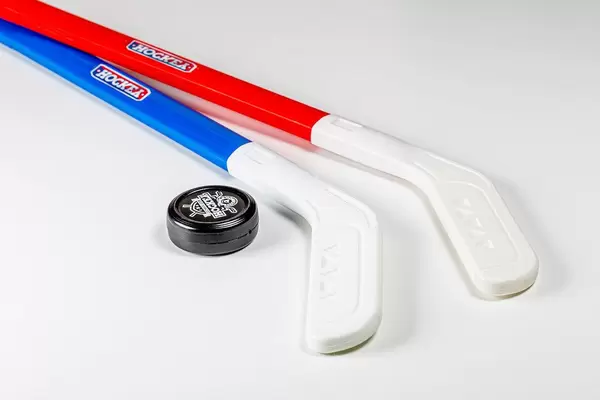 Pair of hockey sticks and puck on a white background (Flip 2020)