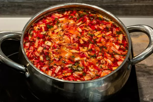 Pan with prepared borscht on a stove