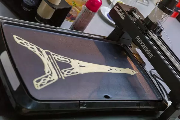 PancakeBot injects crêpe in the form of Eiffel Tower on integrated baking plate