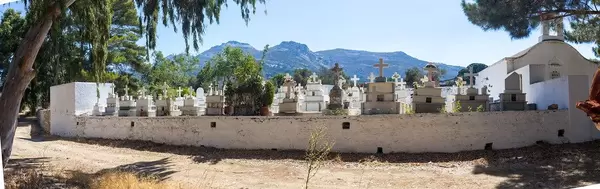 Panoramic photo of cemetery and chapel with graves and crosses. Agios Charalampos near Halki, Naxos