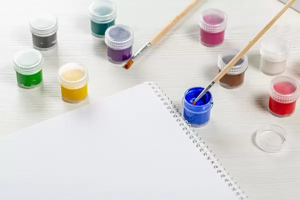 Paper and paint with paintbrush