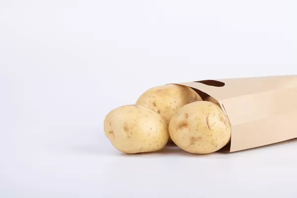 Paper bag full of potatoes
