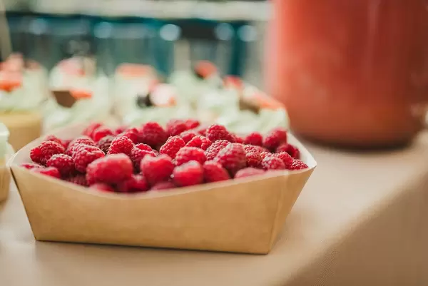Paper Box Full With Fresh And Tasty Raspberries
