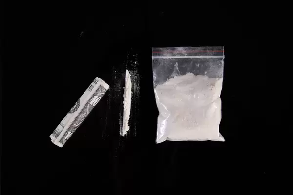 Paper currency and cocaine on table